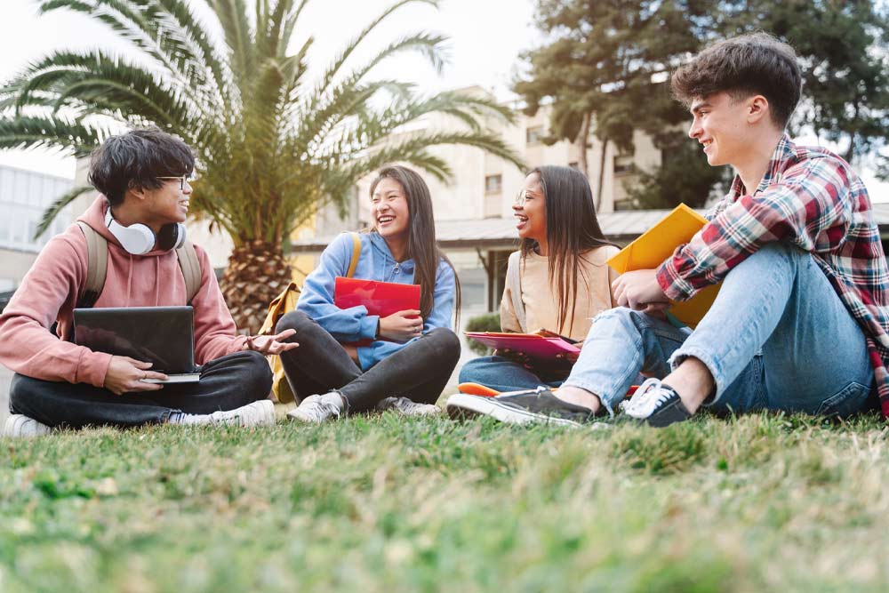 Group of young people hanging out on college campus setting
